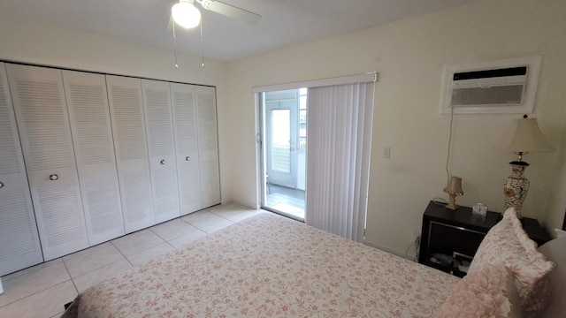 unfurnished bedroom with light tile patterned flooring, a closet, a wall mounted AC, and ceiling fan