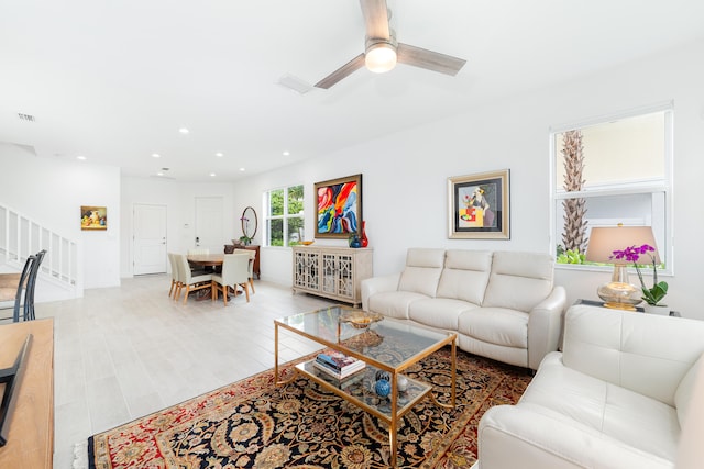 living room featuring hardwood / wood-style flooring and ceiling fan