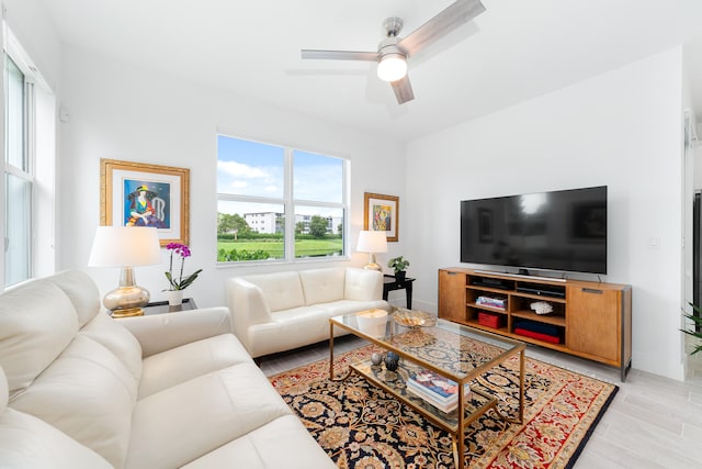 living room featuring ceiling fan and light wood-type flooring