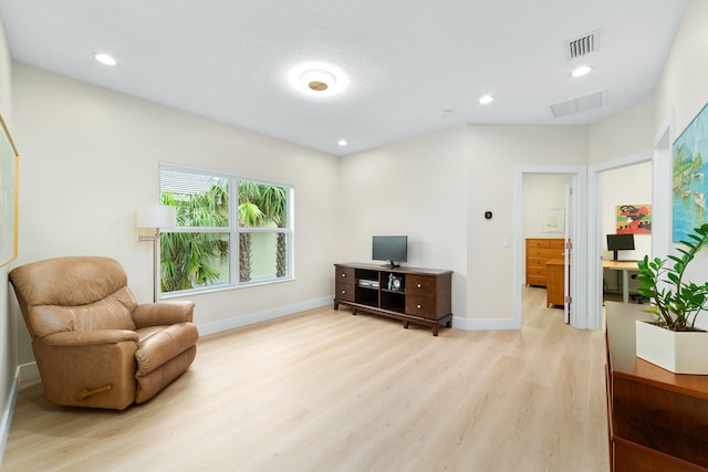 sitting room featuring light hardwood / wood-style floors