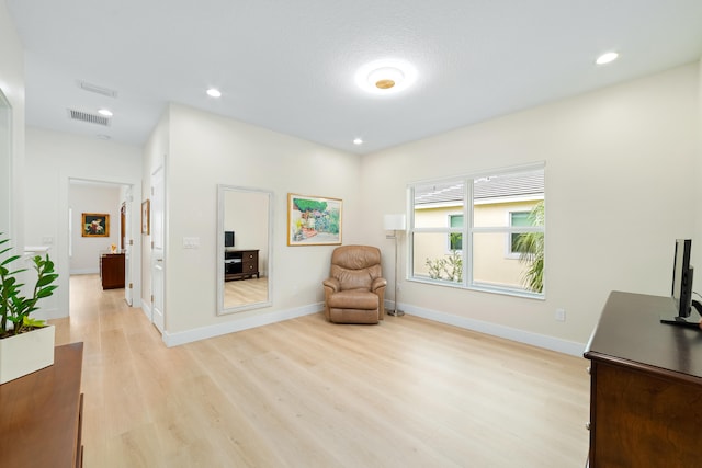 living area with light hardwood / wood-style flooring