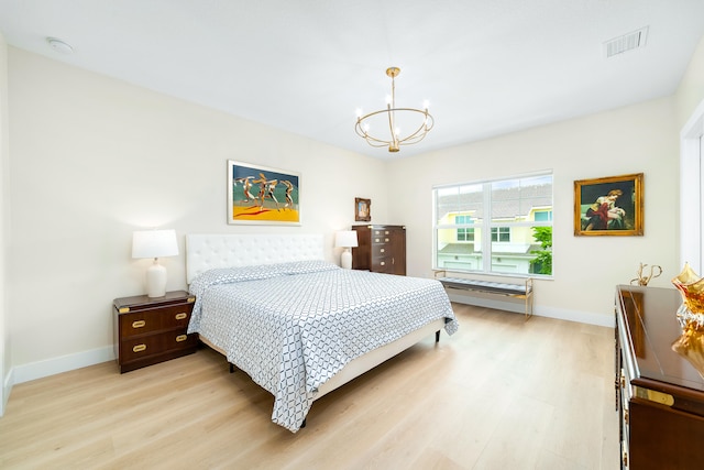 bedroom featuring light hardwood / wood-style flooring and a notable chandelier