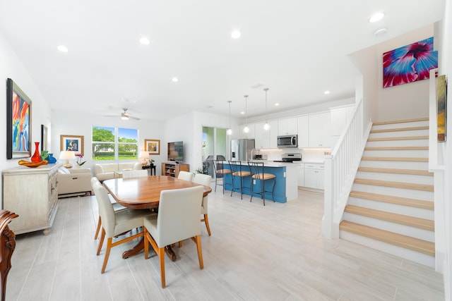 dining area with light hardwood / wood-style flooring and ceiling fan