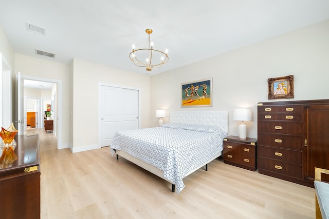 bedroom featuring a closet, a notable chandelier, and light hardwood / wood-style flooring