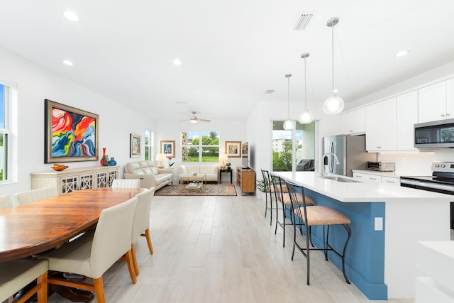 interior space featuring light hardwood / wood-style flooring, sink, and ceiling fan