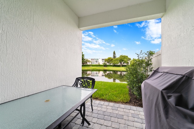 view of patio / terrace with a grill and a water view