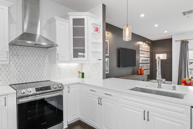 kitchen with wall chimney exhaust hood, white cabinets, sink, and stainless steel electric range