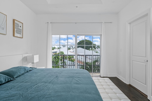 bedroom with access to exterior and dark hardwood / wood-style floors