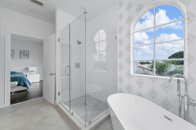 bathroom featuring independent shower and bath, plenty of natural light, and tile patterned floors