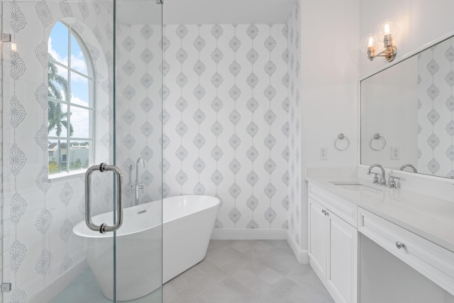 bathroom featuring a tub to relax in, a wealth of natural light, and vanity