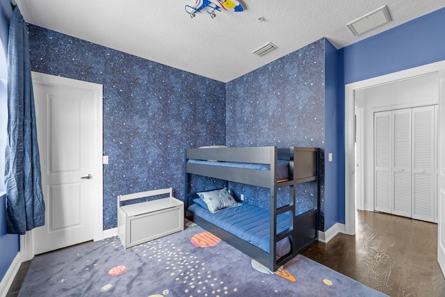 bedroom featuring dark hardwood / wood-style floors and a textured ceiling