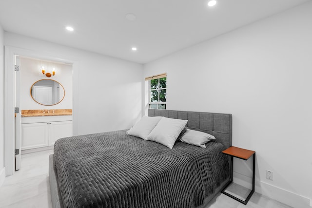 bedroom featuring ensuite bathroom and sink