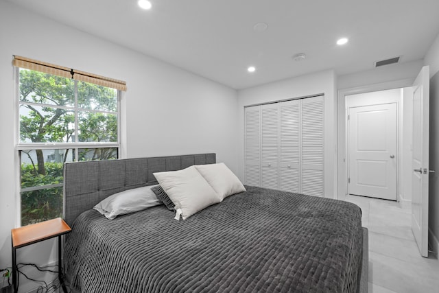 bedroom featuring a closet and light tile patterned floors