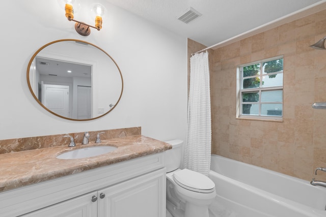 full bathroom featuring shower / tub combo with curtain, vanity, and toilet