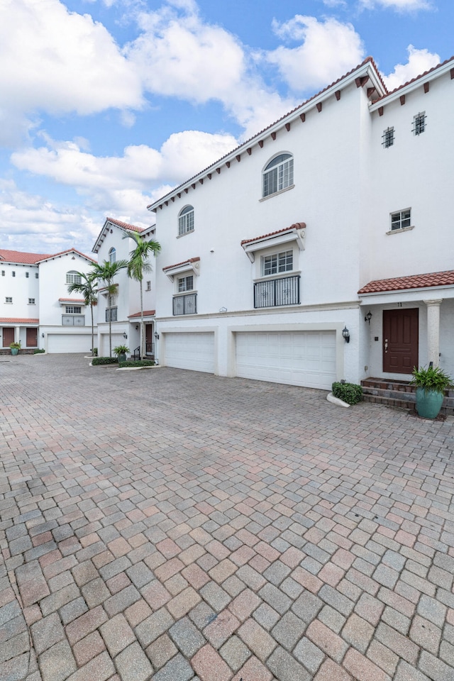 mediterranean / spanish-style home with a garage