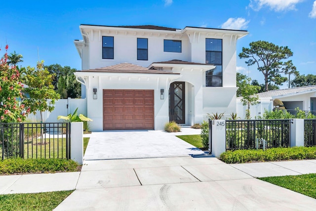 245 Alhambra Pl, West Palm Beach, FL 33405 - view of front of house with a garage, fence private yard, driveway, and stucco siding