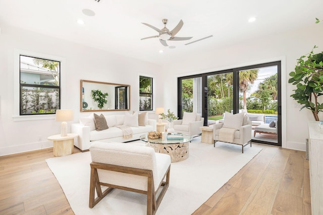 living room featuring ceiling fan and light hardwood / wood-style flooring