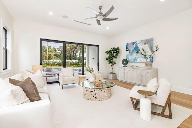 living room featuring ceiling fan and light wood-type flooring