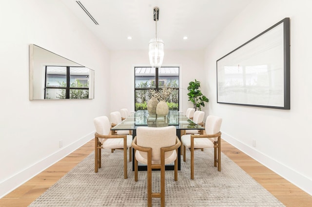 dining room featuring a chandelier and light hardwood / wood-style flooring