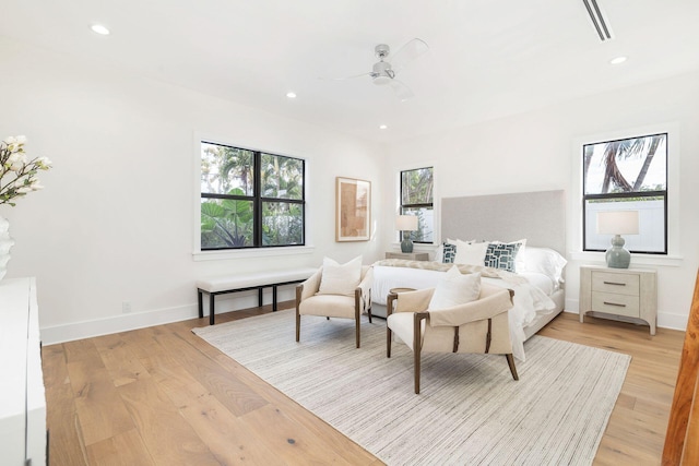 bedroom with light hardwood / wood-style floors and ceiling fan