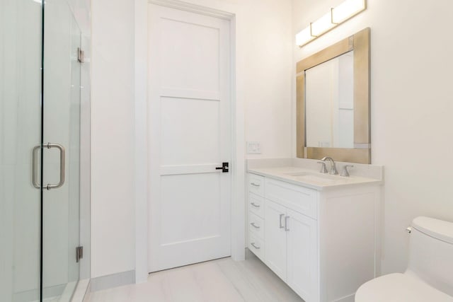 bathroom featuring vanity, walk in shower, and toilet