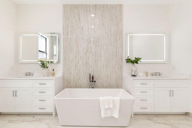 bathroom featuring vanity and a tub