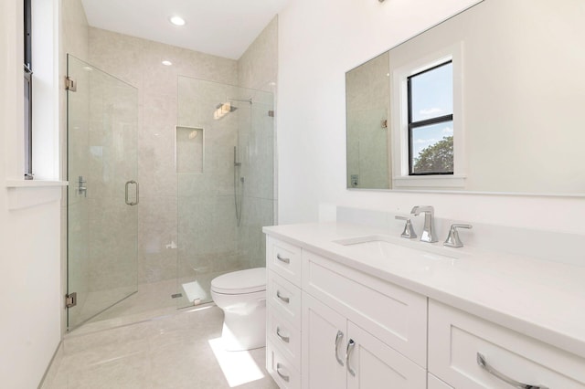 bathroom featuring walk in shower, vanity, and toilet