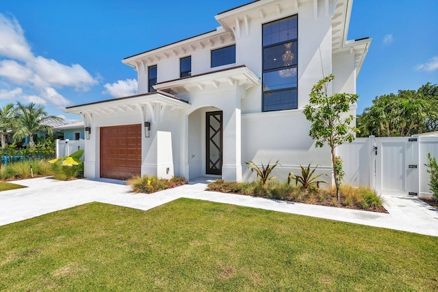 view of front of house with a garage and a front lawn