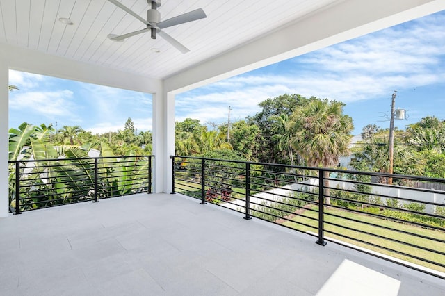 back of house with a swimming pool with hot tub, ceiling fan, a lawn, and a patio area