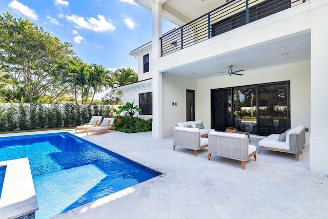 view of swimming pool with ceiling fan, outdoor lounge area, and a patio