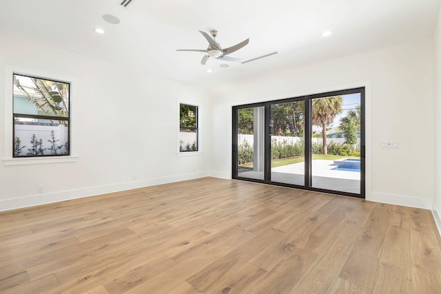 empty room featuring ceiling fan and light hardwood / wood-style floors