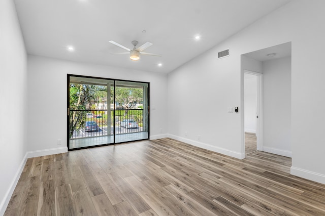 unfurnished room with lofted ceiling, light wood-type flooring, and ceiling fan