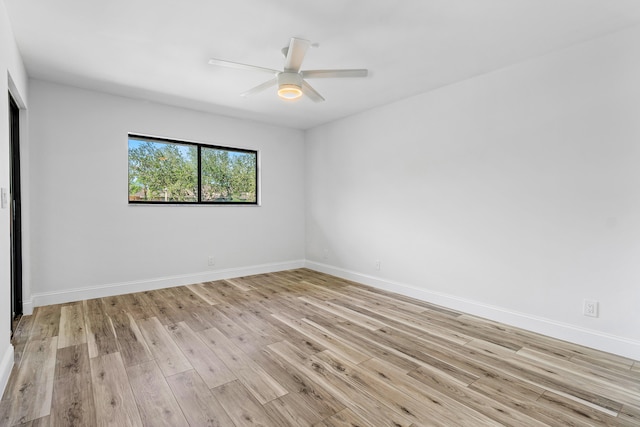 spare room featuring light hardwood / wood-style flooring and ceiling fan