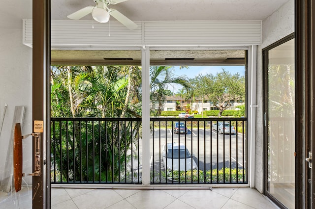 exterior space featuring ceiling fan and tile patterned flooring