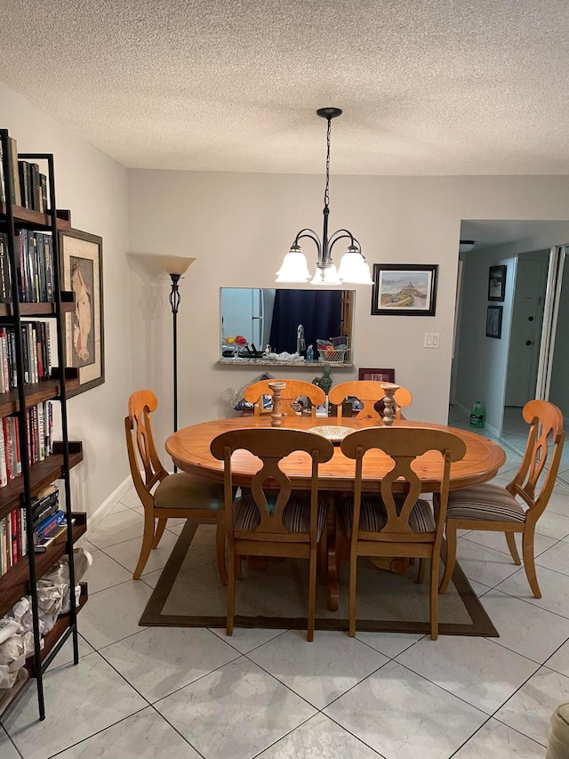 dining room with light tile patterned floors, a textured ceiling, and a notable chandelier