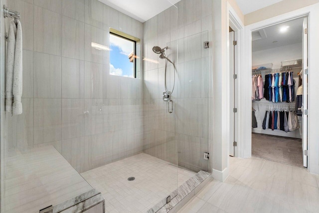 bathroom with tile patterned floors and walk in shower