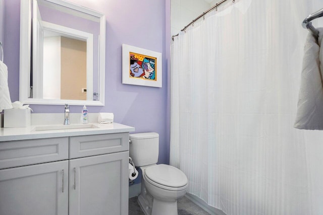 bathroom with toilet, curtained shower, vanity, and tile patterned floors