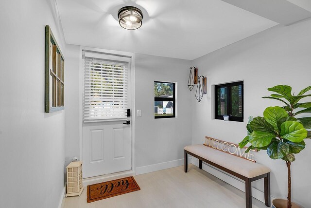 living room with ceiling fan and a wall unit AC