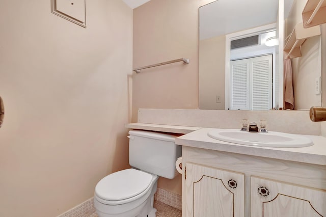 bathroom with tile patterned floors, vanity, and toilet