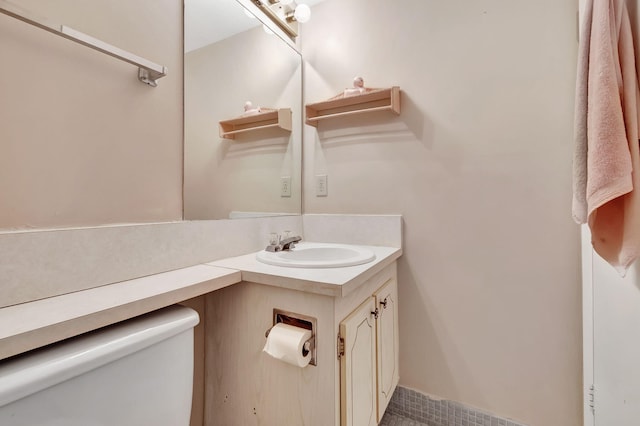 bathroom featuring vanity and toilet