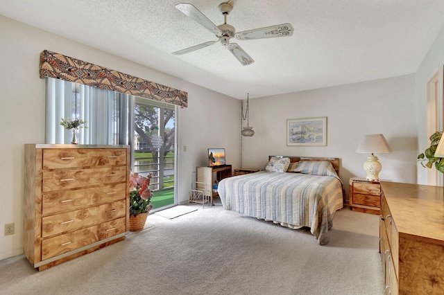 bedroom with access to exterior, a textured ceiling, light colored carpet, and ceiling fan