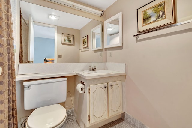 bathroom featuring tile patterned floors, vanity, and toilet