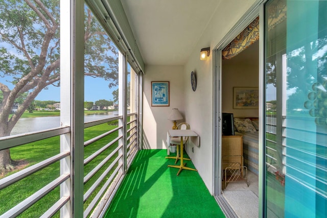 sunroom featuring a water view and a healthy amount of sunlight