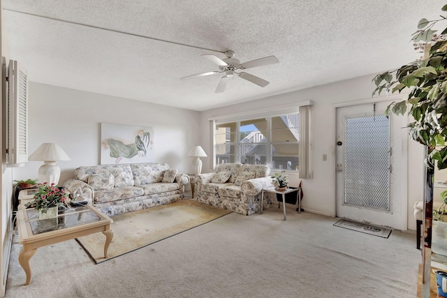 living room featuring carpet, a textured ceiling, and ceiling fan