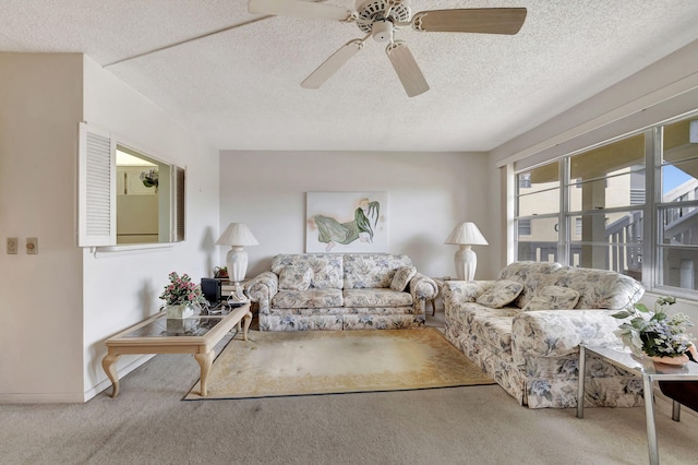 carpeted living room with ceiling fan and a textured ceiling