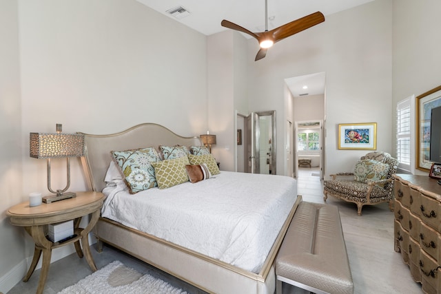 bedroom with a high ceiling and ceiling fan