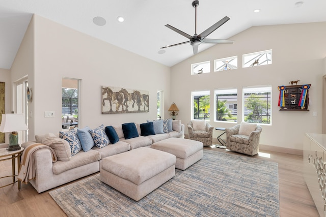 living room featuring high vaulted ceiling, light wood-type flooring, and ceiling fan