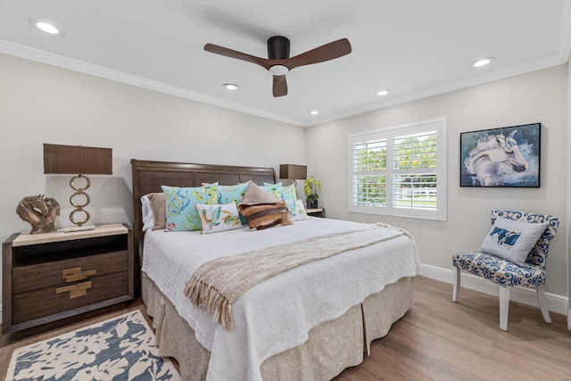 bedroom with crown molding, light hardwood / wood-style flooring, and ceiling fan