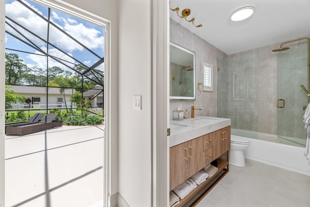 full bathroom featuring vanity, toilet, tile patterned floors, and bath / shower combo with glass door