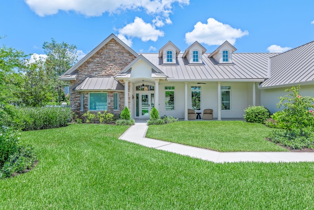 1464 Stallion Dr, Loxahatchee, FL 33470 - view of front of house featuring a standing seam roof, stucco siding, metal roof, a front yard, and ceiling fan